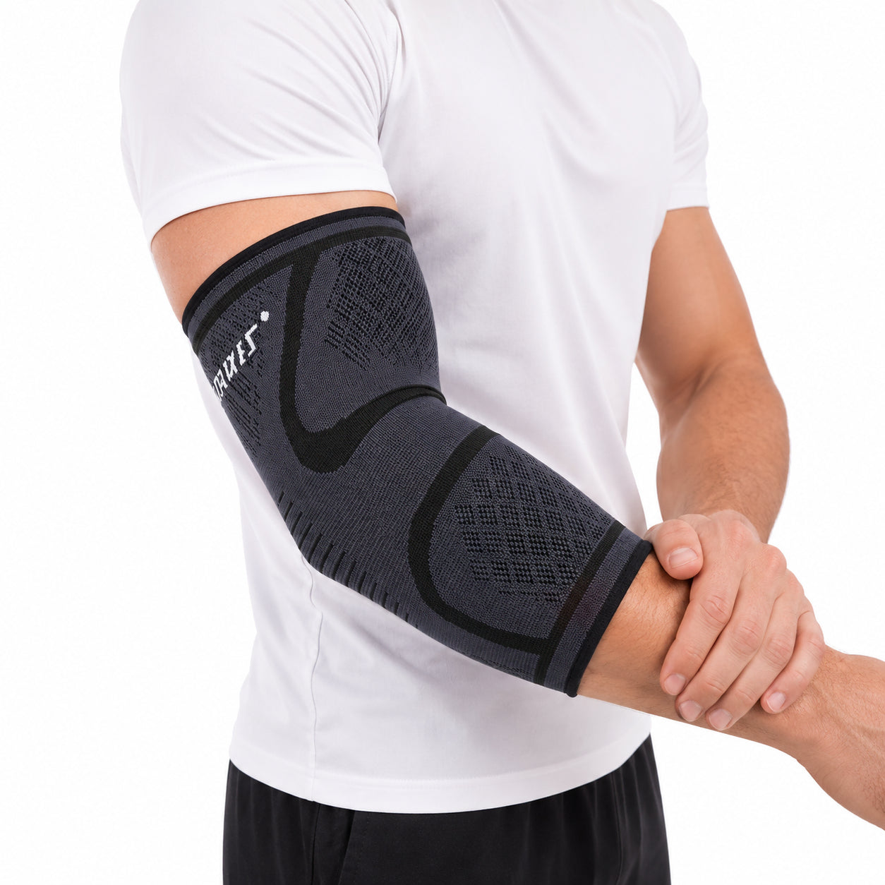 Close-up of a person wearing a black compression elbow sleeve for support and stability.